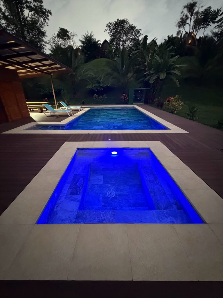 Pool and jacuzzi deck at dusk